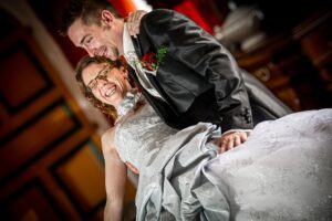 Le marié porte la mariée en riant dans un château Marié portant la mariée en riant dans un château